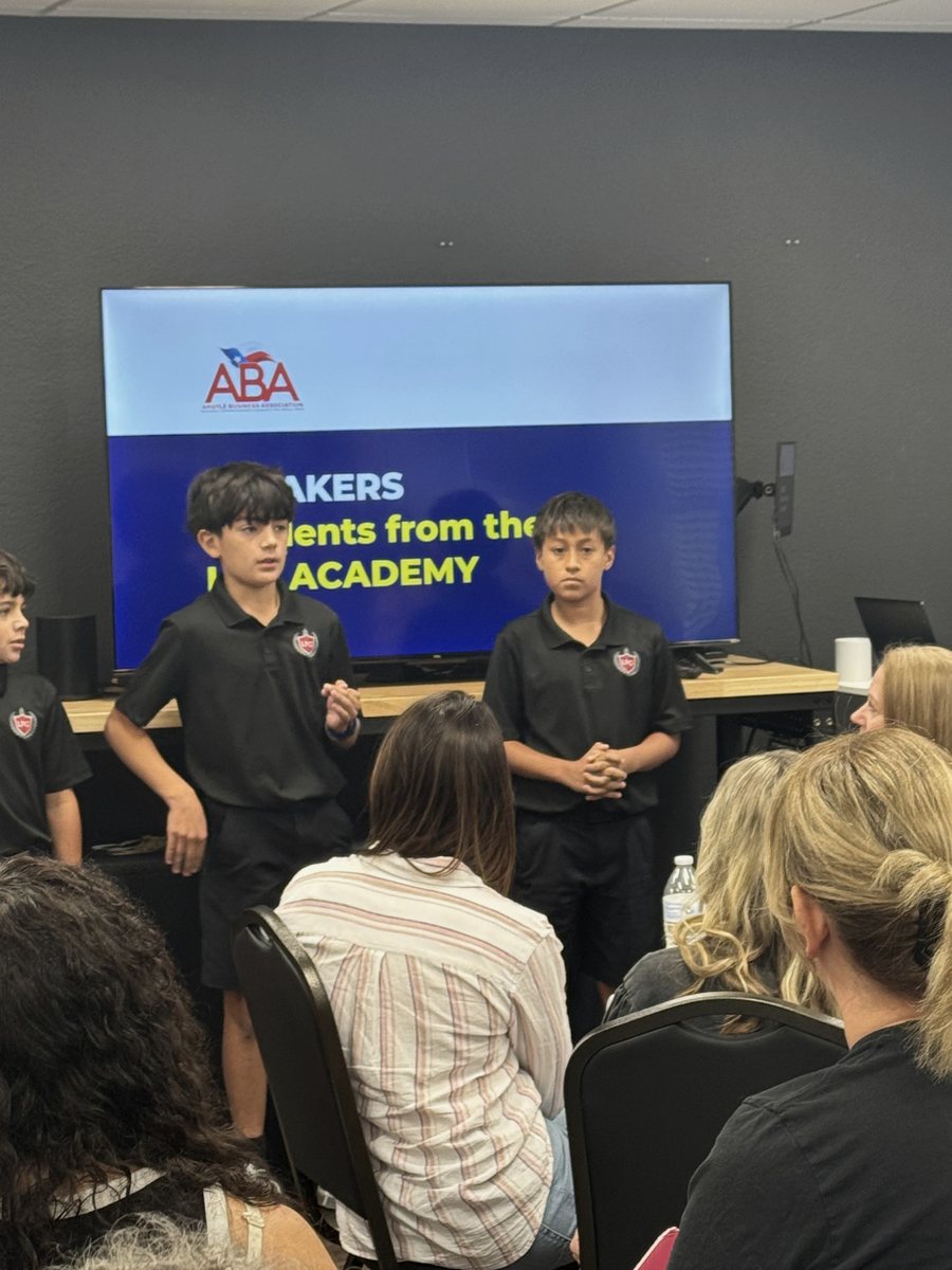 LFG Academy students presenting to an audience at a community luncheon